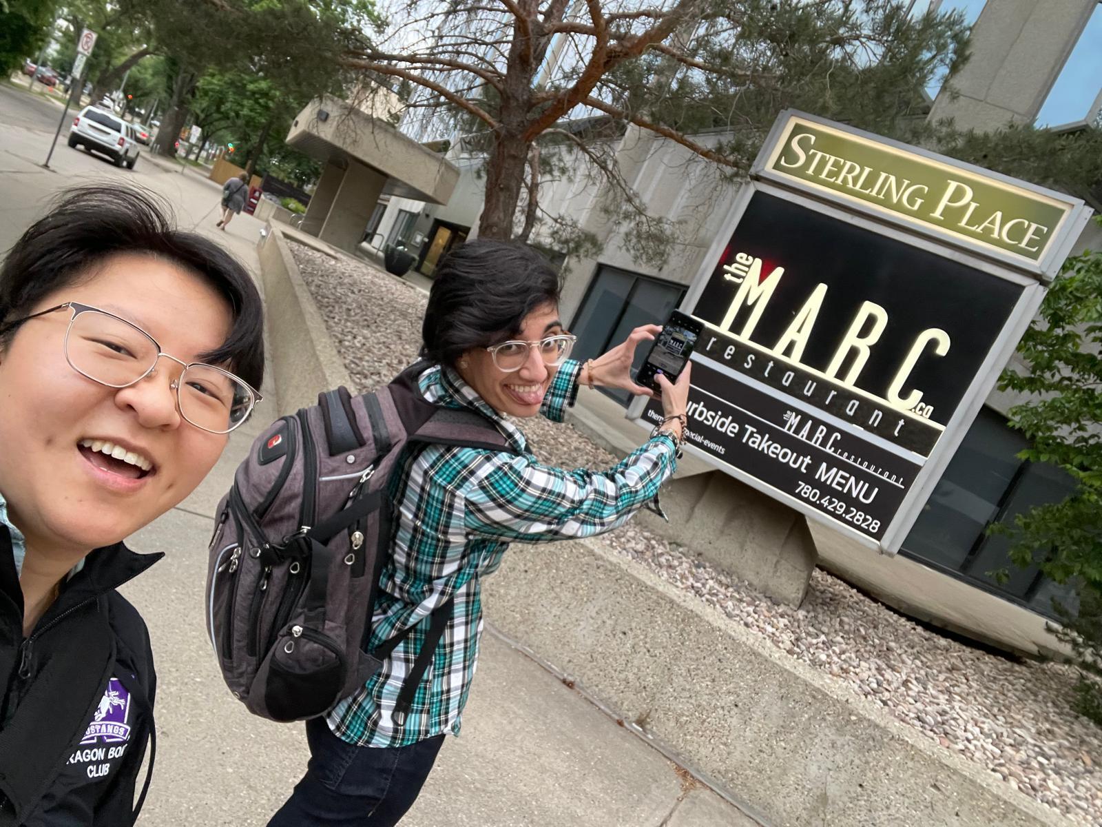 (Deanne Wah (left) and Niki Sinha (right) outside of a restaurant in Edmonton Alberta called The Marc)
